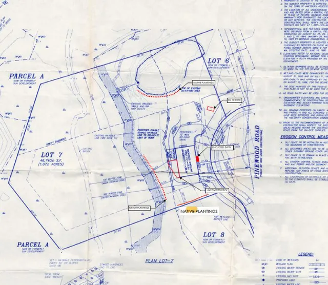 Plan view of Lot 7 showing property boundaries, adjacent parcels, existing conditions, and proposed conservation measures such as native plantings, a proposed deck, and an enclosed entry along Pinewood Road.