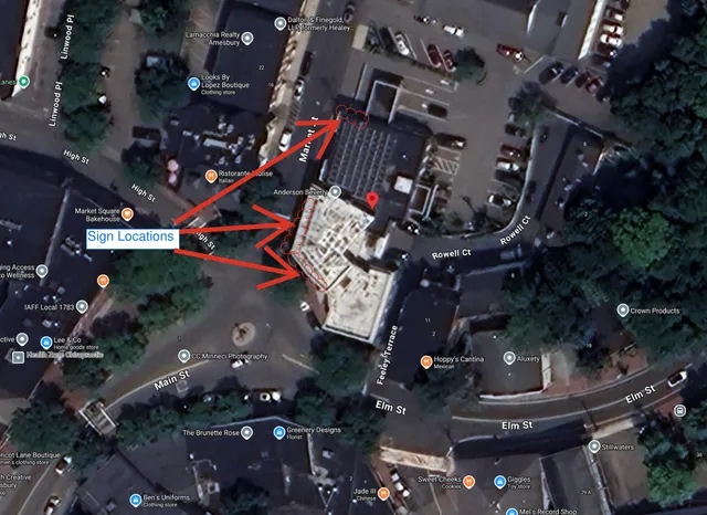 Annotated aerial map of downtown Amesbury showing the 5 Market St area and proposed sign locations marked with red arrows and circled points near Market St, High St, and Rowell Ct.