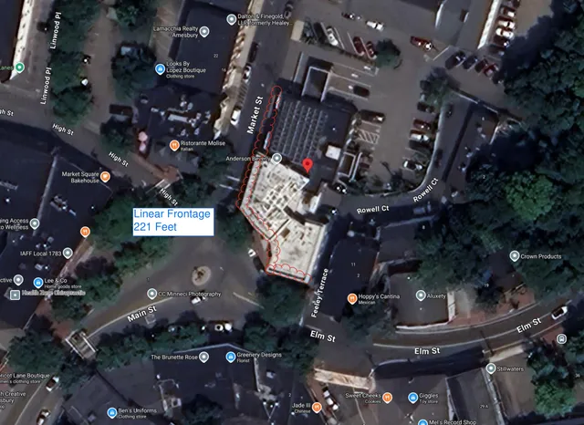 Annotated satellite map of the downtown Amesbury area showing the 5 Market St site outlined in red and labeled “Linear Frontage 221 Feet.” Nearby streets and businesses are visible around the highlighted property frontage.