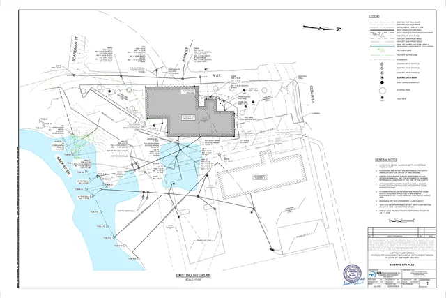 Existing site plan showing the 15 Cedar St. / 25 Cedar St. area, with building footprints, topography, drainage structures, wetland and flood zone delineations, utility lines, and the Back River frontage. The plan includes north arrow, legend, notes, and a title block identifying it as an existing site plan.