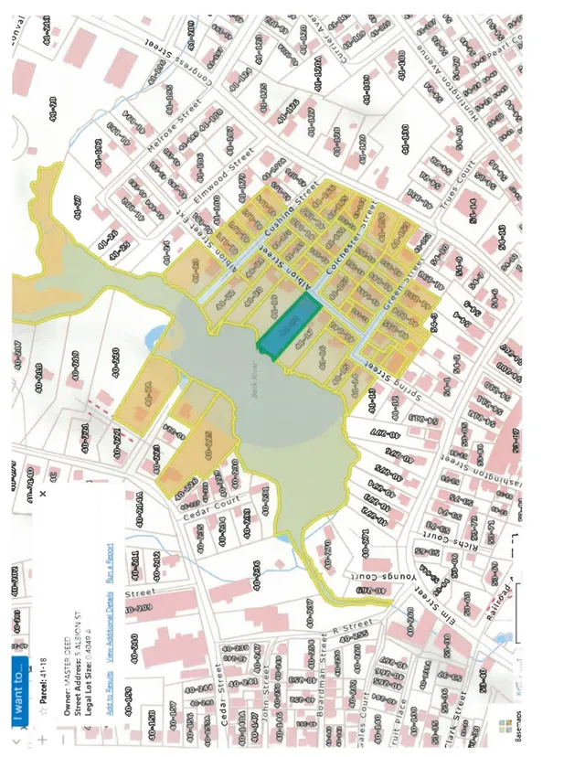 A parcel map showing the 5 Albion St area and surrounding streets, with the project parcel highlighted in blue/green and nearby parcels outlined in yellow. The map includes lot numbers, street names, and a large shaded open-space/water area nearby.