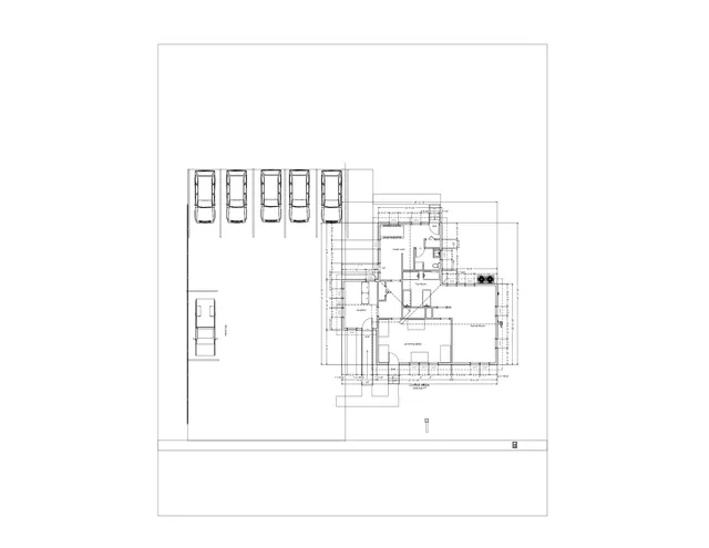 Plan view of the proposed layout showing the building footprint, parking spaces, and labeled interior rooms including reception, break room, tub room, kennel room, and grooming tables. The drawing also includes dimensions, circulation paths, and site boundaries.