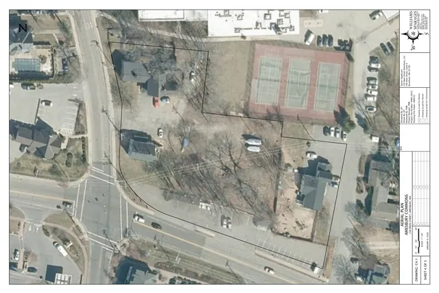 Aerial orthophoto of the 230 Main Street area with the project parcel outlined in black and adjacent buildings, parking lots, and streets visible around it. The sheet is labeled as an aerial plan for Amesbury Commons.